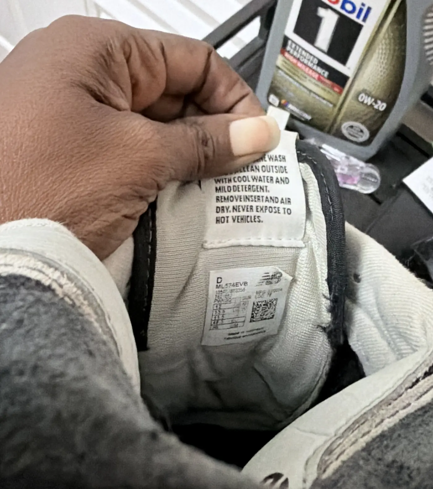 Close-up of a New Balance tongue label reading width D and style ML574EVB